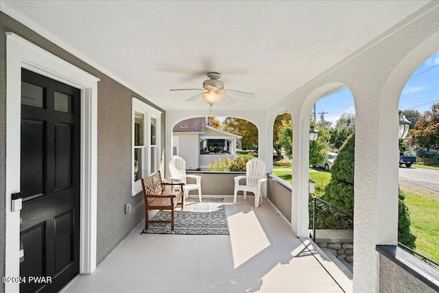 exterior space with a porch and ceiling fan