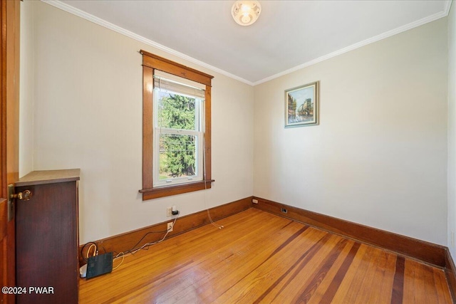 spare room with hardwood / wood-style floors and ornamental molding