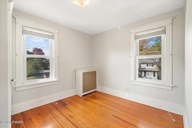 empty room with radiator and wood-type flooring