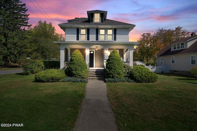 view of front of house with a lawn and covered porch