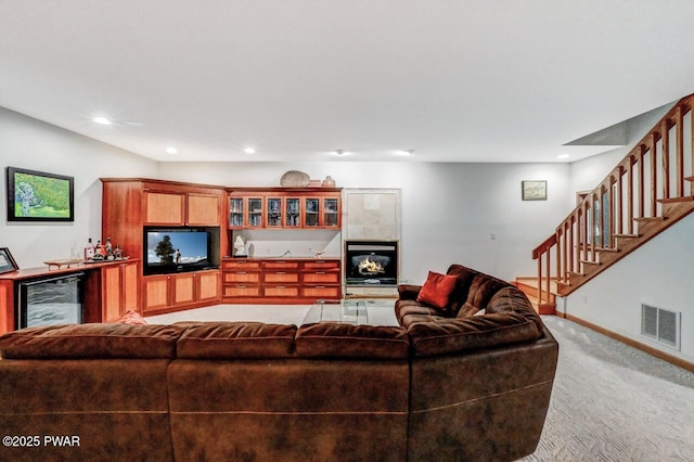 carpeted living room with wine cooler and indoor bar