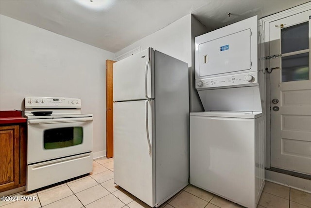 kitchen featuring white appliances, stacked washing maching and dryer, and light tile patterned flooring