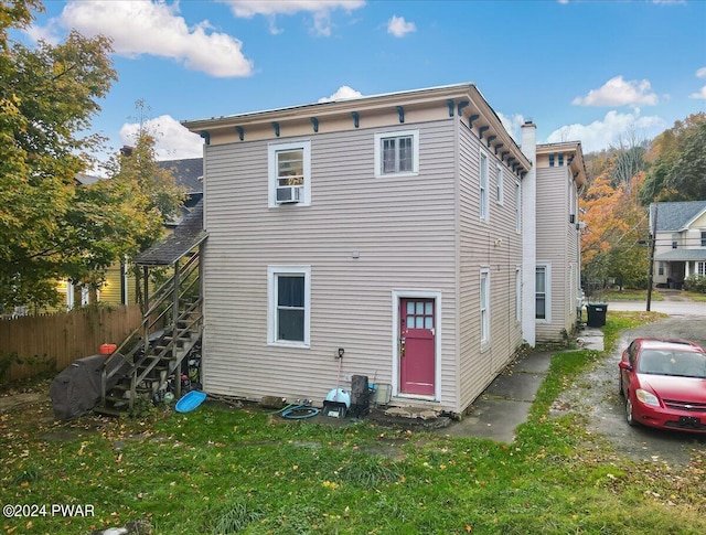 back of property featuring cooling unit