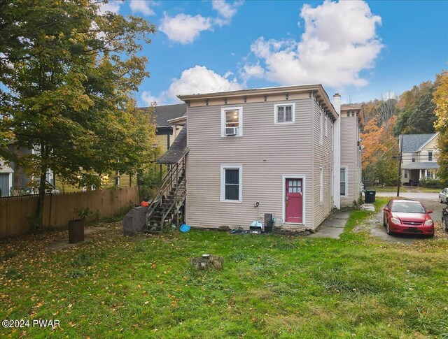 rear view of house with a lawn