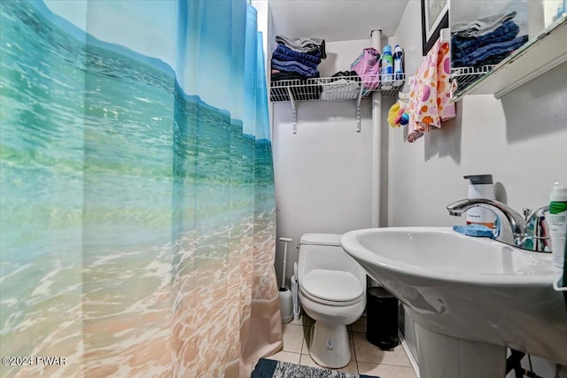 bathroom featuring tile patterned flooring and toilet