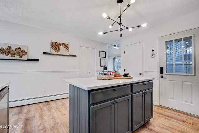 kitchen featuring pendant lighting, a kitchen island, light wood-type flooring, gray cabinetry, and baseboard heating