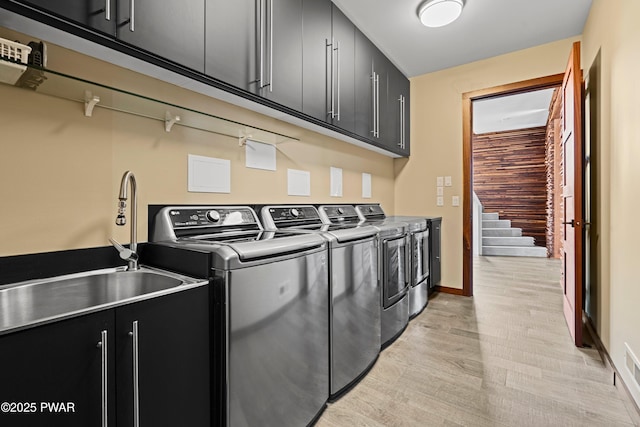 122 Overlook Ln, Lords Valley, PA 18428 - washroom featuring separate washer and dryer, cabinet space, light wood-type flooring, and baseboards