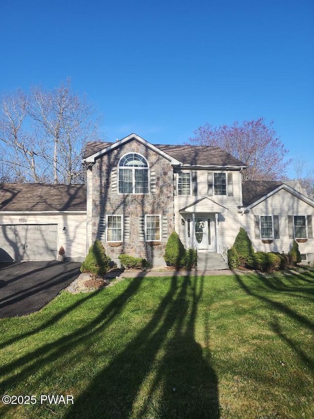 814 Clearview Dr, Long Pond, PA 18334 - view of front of home with stone siding, aphalt driveway, a front yard, and a garage