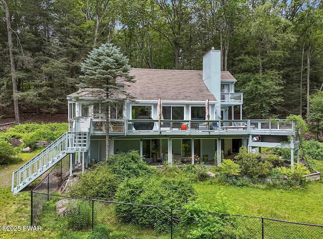 115 Washington Dr, Lords Valley, PA 18428 - rear view of property featuring stairway, a chimney, a deck, and a wooded view