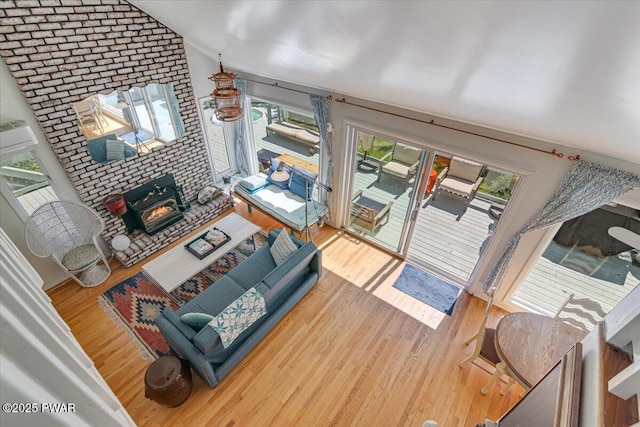 115 Washington Dr, Lords Valley, PA 18428 - living room with vaulted ceiling, wood finished floors, and a wood stove