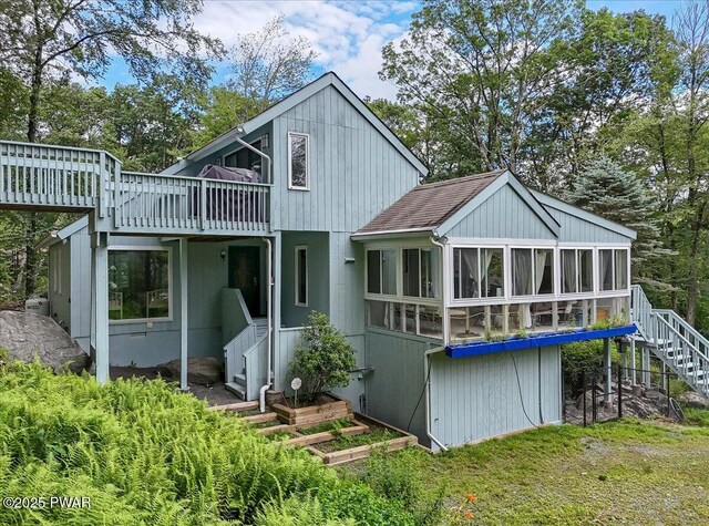 115 Washington Dr, Lords Valley, PA 18428 - back of property with stairway, a sunroom, a wooden deck, and a shingled roof