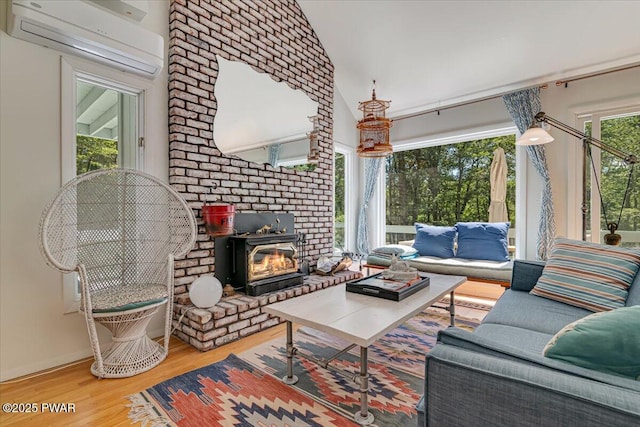115 Washington Dr, Lords Valley, PA 18428 - living area with a wall mounted AC, wood finished floors, and vaulted ceiling