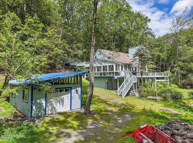 115 Washington Dr, Lords Valley, PA 18428 - back of property with stairway, a deck, a wooded view, a metal roof, and a lawn