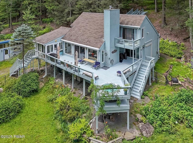115 Washington Dr, Lords Valley, PA 18428 - rear view of house featuring stairway, a chimney, roof with shingles, and a deck