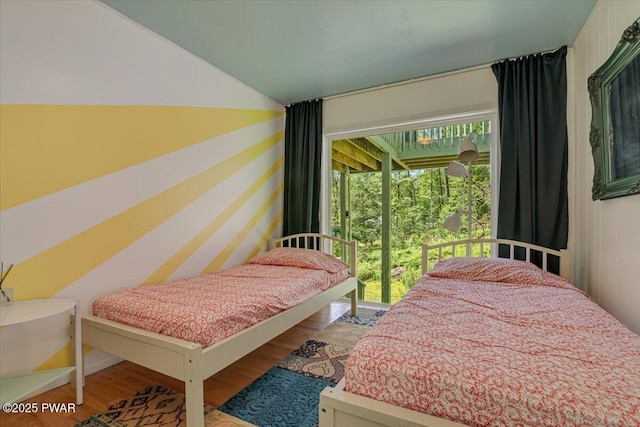 115 Washington Dr, Lords Valley, PA 18428 - bedroom with wood finished floors, vaulted ceiling, and access to outside