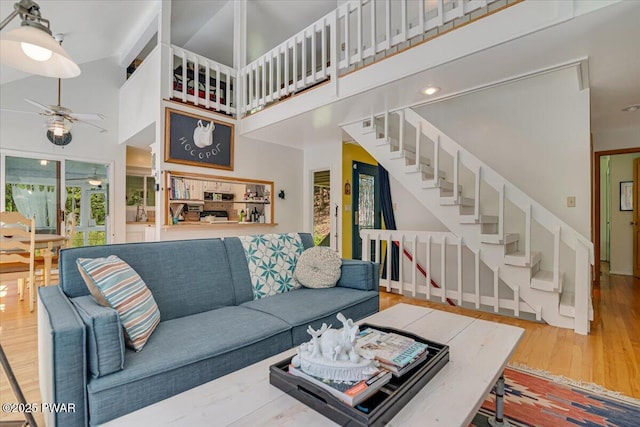 115 Washington Dr, Lords Valley, PA 18428 - living area with ceiling fan, wood finished floors, a high ceiling, and stairs