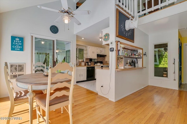 115 Washington Dr, Lords Valley, PA 18428 - dining area with light wood-type flooring, a ceiling fan, and a towering ceiling