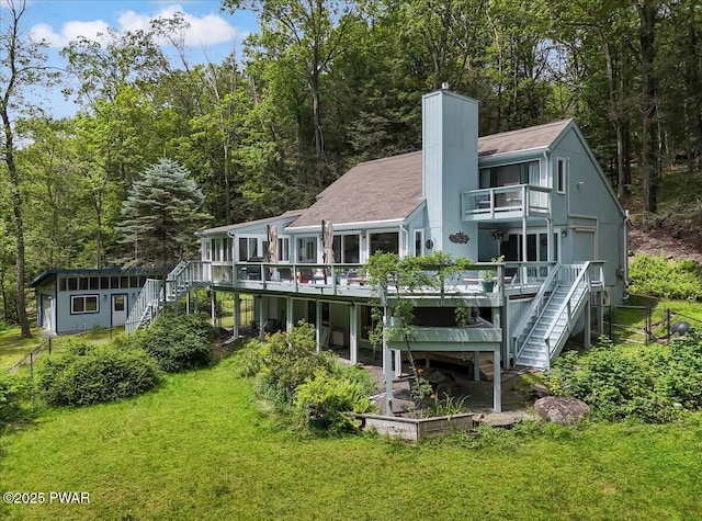 115 Washington Dr, Lords Valley, PA 18428 - rear view of house with stairs, a balcony, a yard, a chimney, and a wooden deck