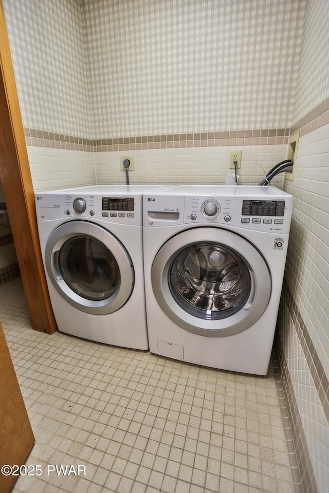 216 Canterbrook Dr, Lords Valley, PA 18328 - laundry area with wallpapered walls, washer and dryer, tile walls, and a wainscoted wall