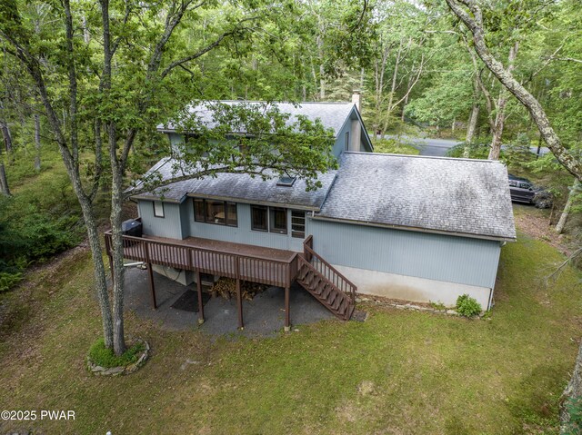 216 Canterbrook Dr, Lords Valley, PA 18328 - back of house featuring a shingled roof, a wooden deck, stairway, and a yard