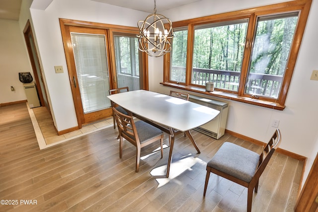 216 Canterbrook Dr, Lords Valley, PA 18328 - dining area featuring light wood-style flooring, healthy amount of natural light, and a chandelier