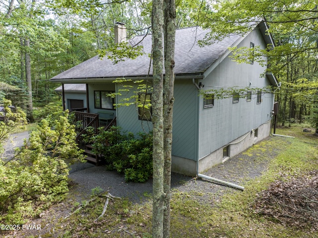 216 Canterbrook Dr, Lords Valley, PA 18328 - view of side of home with a shingled roof and a chimney