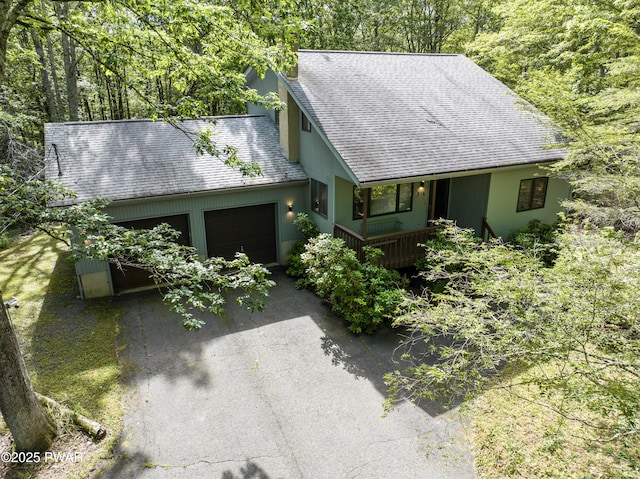 216 Canterbrook Dr, Lords Valley, PA 18328 - view of front of house with a shingled roof, driveway, and an attached garage