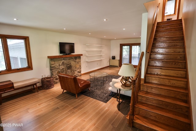 216 Canterbrook Dr, Lords Valley, PA 18328 - living room featuring wood finished floors, stairs, built in shelves, a fireplace, and recessed lighting