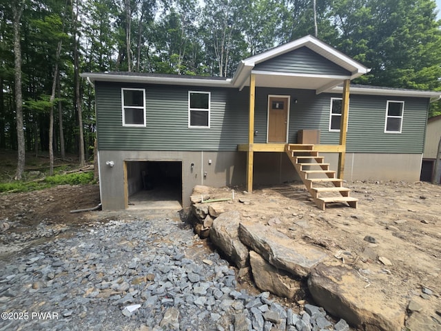 72 Lakeview Dr, Lake Ariel, PA 18436 - view of front of home with an attached garage, dirt driveway, and view of scattered trees