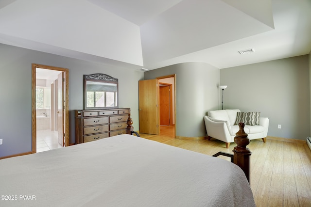 2766 Owego Tpke, Hawley, PA 18428 - bedroom featuring baseboards, wood finished floors, and ensuite bathroom