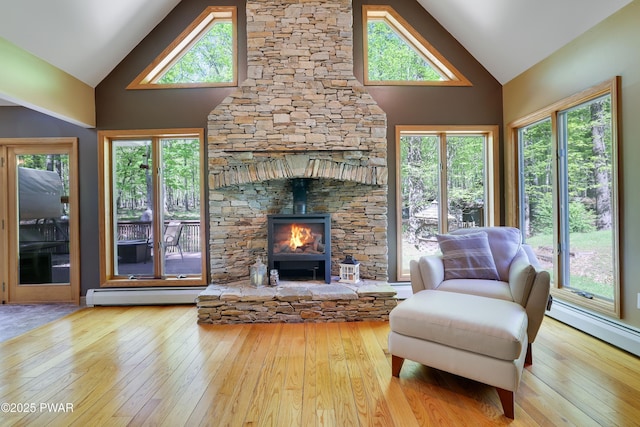 2766 Owego Tpke, Hawley, PA 18428 - living room with a baseboard radiator, high vaulted ceiling, hardwood / wood-style floors, and healthy amount of natural light