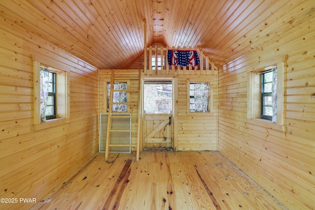 2766 Owego Tpke, Hawley, PA 18428 - spare room with wooden walls, vaulted ceiling, plenty of natural light, wood-type flooring, and wooden ceiling