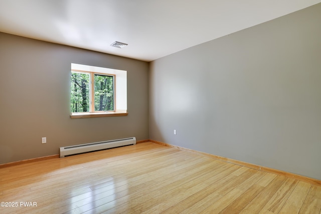 2766 Owego Tpke, Hawley, PA 18428 - unfurnished room with a baseboard radiator, wood finished floors, and baseboards