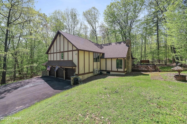 2766 Owego Tpke, Hawley, PA 18428 - english style home featuring driveway, a garage, roof with shingles, a chimney, and board and batten siding