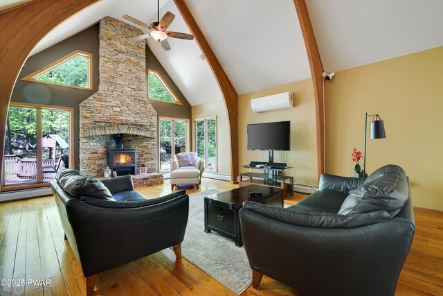 2766 Owego Tpke, Hawley, PA 18428 - living area with high vaulted ceiling, an AC wall unit, hardwood / wood-style floors, ceiling fan, and beam ceiling