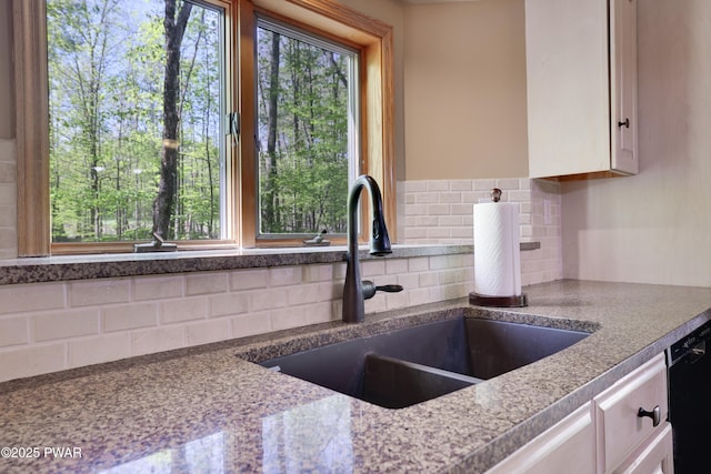 2766 Owego Tpke, Hawley, PA 18428 - kitchen with a sink, decorative backsplash, and white cabinetry