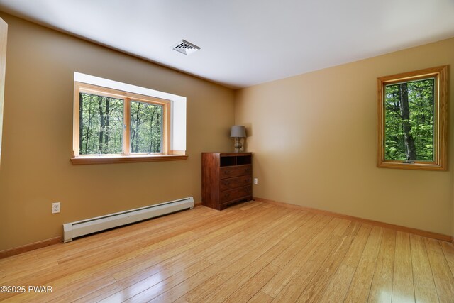 2766 Owego Tpke, Hawley, PA 18428 - unfurnished room featuring baseboard heating, hardwood / wood-style floors, and baseboards