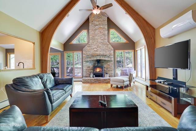2766 Owego Tpke, Hawley, PA 18428 - living area with a wall unit AC, wood finished floors, ceiling fan, high vaulted ceiling, and beamed ceiling