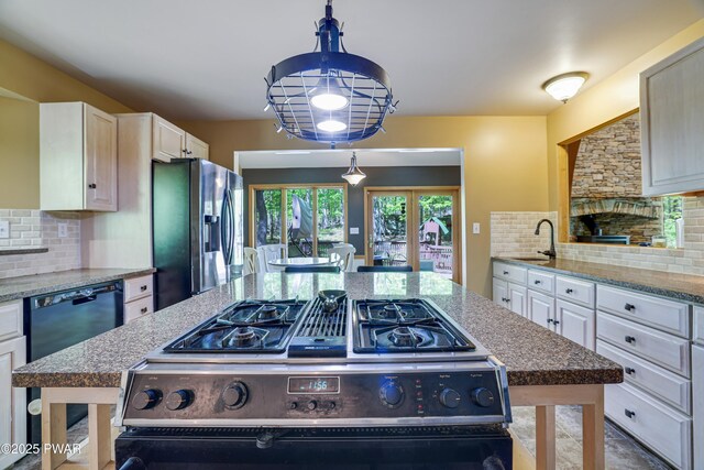 2766 Owego Tpke, Hawley, PA 18428 - kitchen with stainless steel appliances, decorative backsplash, a sink, and light stone countertops