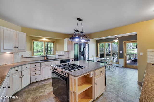 2766 Owego Tpke, Hawley, PA 18428 - kitchen featuring gas stove, stainless steel fridge, a sink, and tasteful backsplash