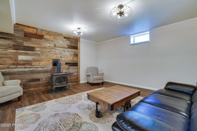 2766 Owego Tpke, Hawley, PA 18428 - living area with a wood stove, wooden walls, wood finished floors, ornamental molding, and baseboards