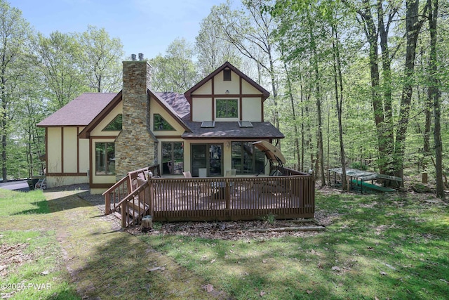 2766 Owego Tpke, Hawley, PA 18428 - rear view of house featuring a shingled roof, a chimney, a lawn, and a deck