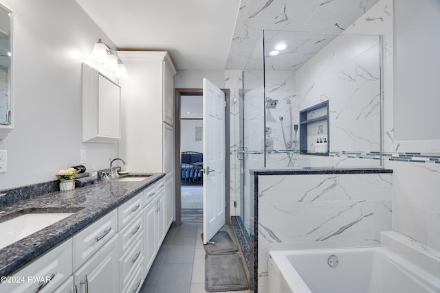 bathroom featuring tile patterned flooring, vanity, and separate shower and tub