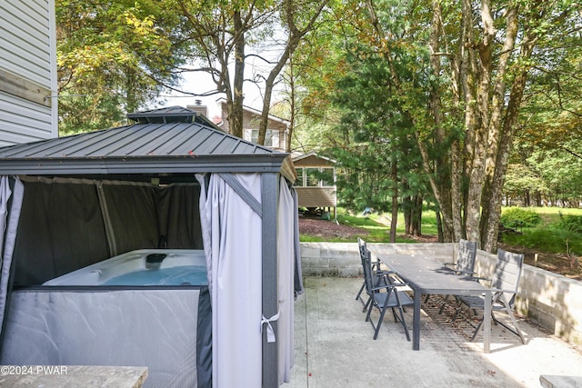 view of patio / terrace with a gazebo and a hot tub