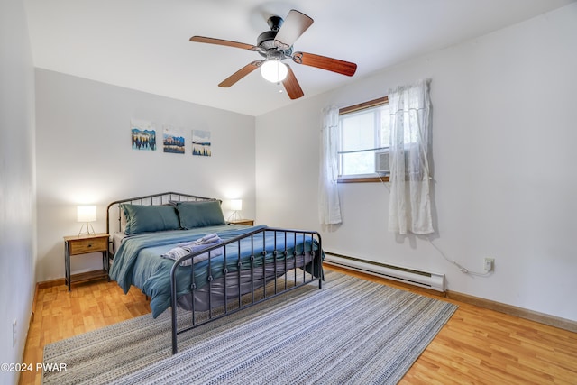 bedroom featuring ceiling fan, cooling unit, a baseboard radiator, and wood-type flooring