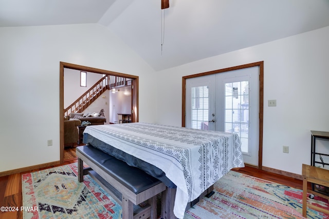 bedroom featuring ceiling fan, french doors, vaulted ceiling, and light wood-type flooring