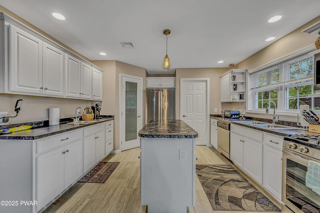 1011 Salem Pl, Lake Ariel, PA 18436 - kitchen with stainless steel appliances, dark countertops, a sink, light wood finished floors, and recessed lighting