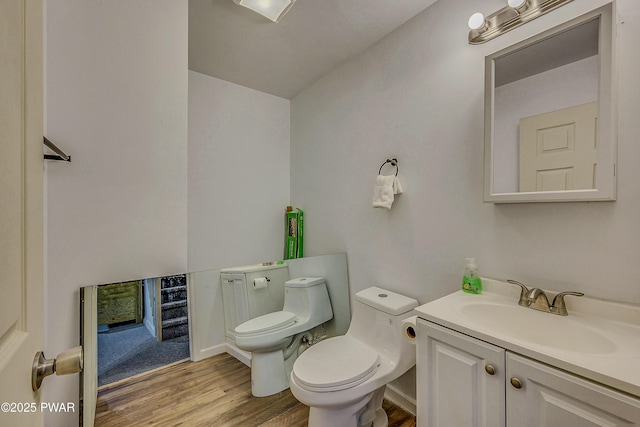 1011 Salem Pl, Lake Ariel, PA 18436 - half bathroom featuring vanity, toilet, wood finished floors, and baseboards