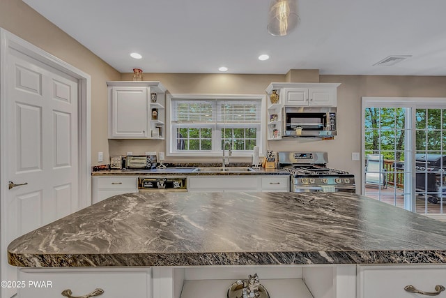 1011 Salem Pl, Lake Ariel, PA 18436 - kitchen featuring stainless steel appliances, a sink, white cabinetry, recessed lighting, and dark stone counters