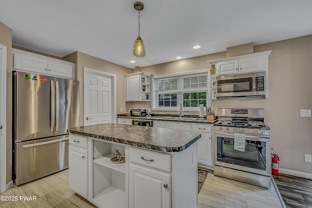 1011 Salem Pl, Lake Ariel, PA 18436 - kitchen with appliances with stainless steel finishes, open shelves, dark countertops, a sink, and white cabinets